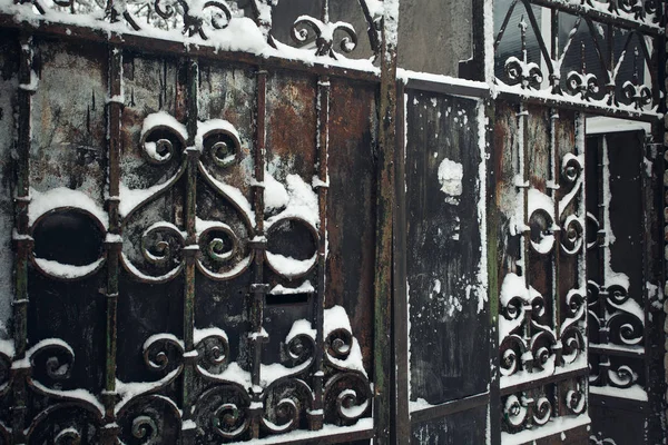 Old city walls in winter concept. Black rustic metal gates — Stock Photo, Image