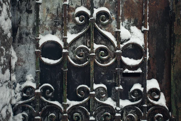 Old city walls in winter concept. Black rustic metal gates — Stock Photo, Image