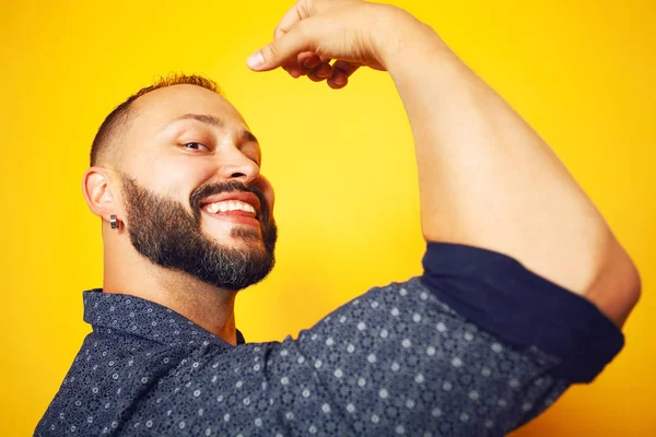 We can do it concept. Close up portrait of charismatic mature man showing his bicep