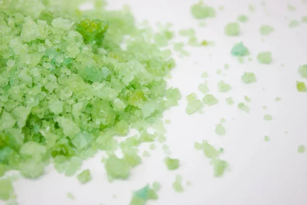 Green crystals of sea salt on a white background, blue sea salt on background, sea salt on a white background, Green crystals background