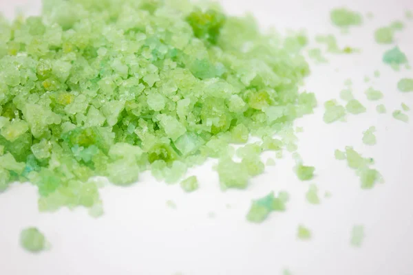 Green crystals of sea salt on a white background, blue sea salt on background, sea salt on a white background, Green crystals background
