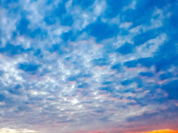 Cloudy before sunset sky, Blur blue pastel heaven clouds sky background. Soft focus lans flare sunlight. Abstract blurred cyan gradient with beautiful bokeh. Open view out windows summer spring, sunset sky with cirrus clouds and trace of airplane