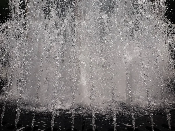 fragment of fountain water drops in the air, Fountain spraying in air making splash background, fragment of fountain water drops in the air Fountain of water drops