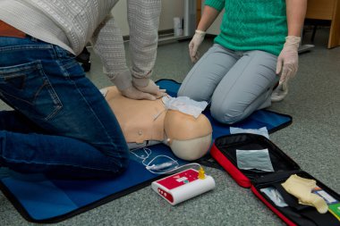 First aid cardiopulmonary resuscitation course using automated external defibrillator device, AED. clipart