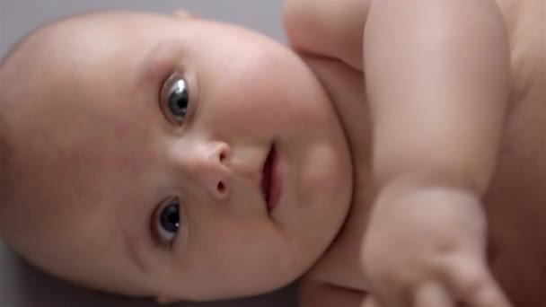 Close up of baby lies on his back. Top view. — Stock Video