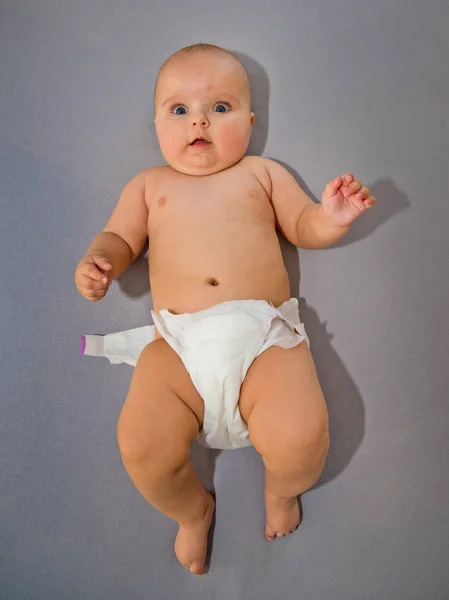 Baby Takes His Diaper Grey Background Top View — Stock Photo, Image