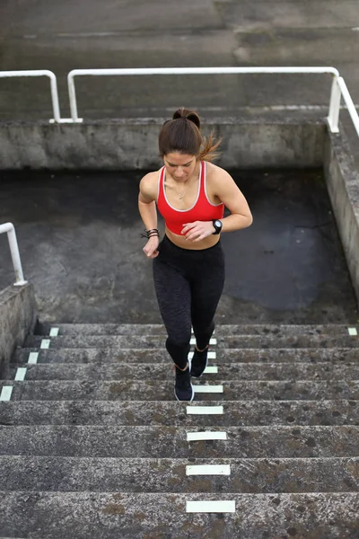 Woman running and climbing stairs. — Stock Photo, Image