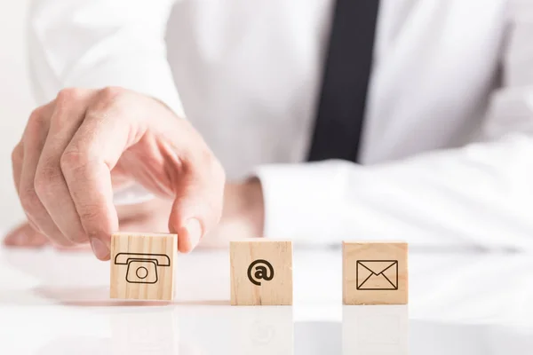 Businessman Placing Wooden Cubes White Table Email Phone Pictograms Business — Stock Photo, Image