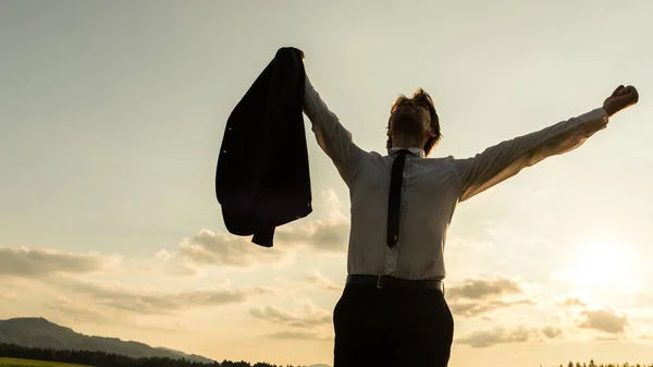 Businessman Standing Evening Nature His Arms Raised High Air Holding — Stock Photo, Image