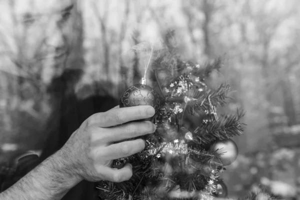 Young Man Carefully Placing Christmas Ball Holiday Tree View Window — Stock Photo, Image