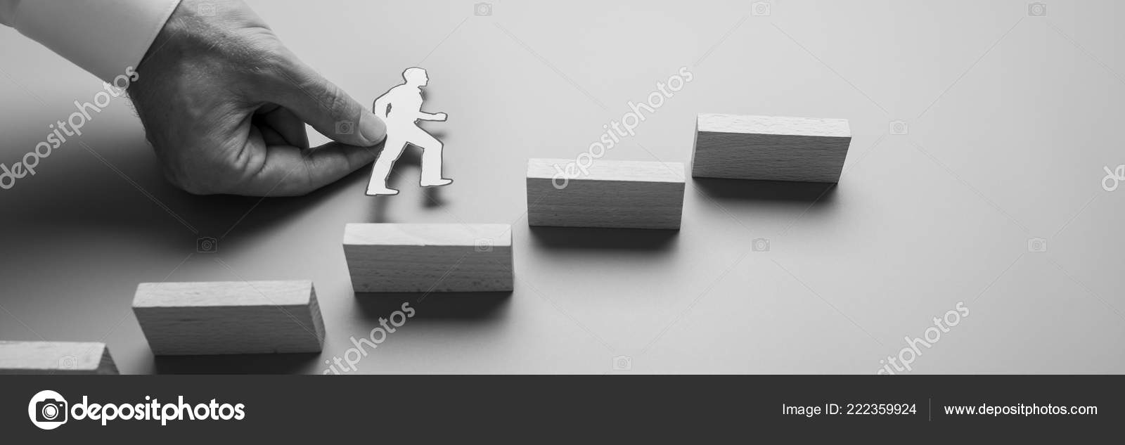 Black White Wide View Image Businessman Holding Paper Cut Man Black And White Wide View Image Of A Businessman Holding Paper Cut Man Climbing Up The Stairs Wooden Pegs Stock