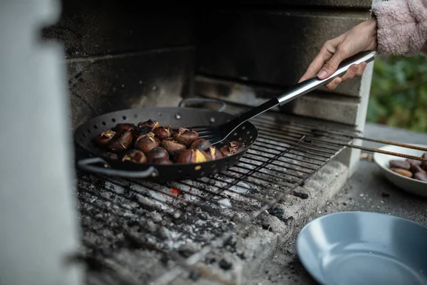 Closeup View Woman Roasting Delicious Chestnuts Backyard Grill — Stock Photo, Image