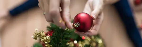 Top View Female Hands Placing Red Holiday Ball Christmas Tree — Stock Photo, Image