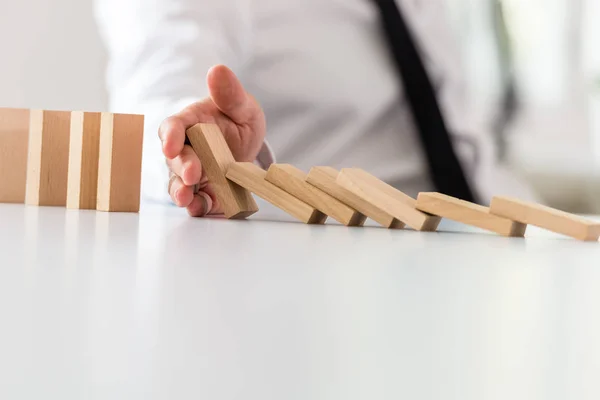 Business Intervention Concept Businessman Putting Stop Collapsing Dominos His Hand — Stock Photo, Image