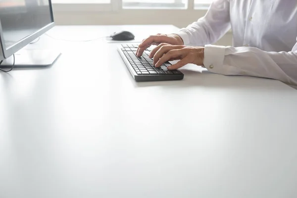 Programmer or student sitting at his office desk working using computer.