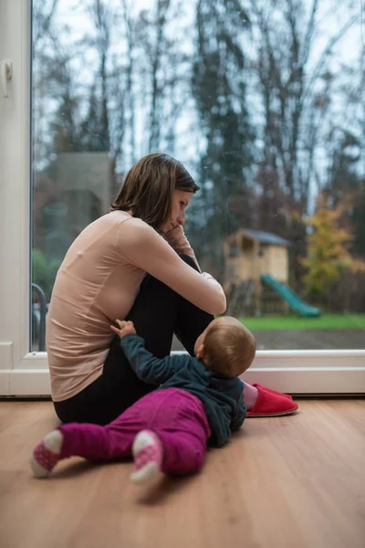 Young Mother Sitting Worried Depressed Window Living Room Her Baby — Stock Photo, Image