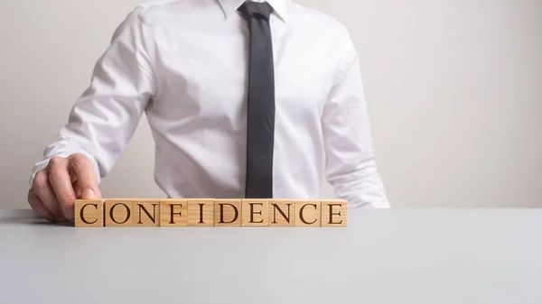 Empresario Sentado Escritorio Oficina Con Cubos Madera Deletreo Confianza Frente — Foto de Stock