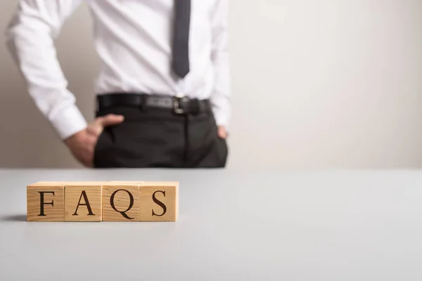 Wooden Cubes Spelling Faqs Businessman Standing Background Copy Space — Stock Photo, Image