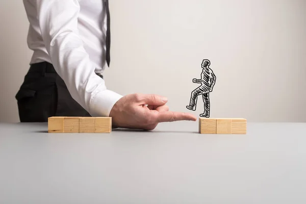 Businessman making a bridge of his finger for a silhouetted busi — Stock Photo, Image