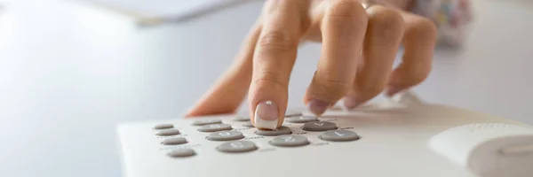 Woman with perfect french manicure dialing a telephone number — Stock Photo, Image