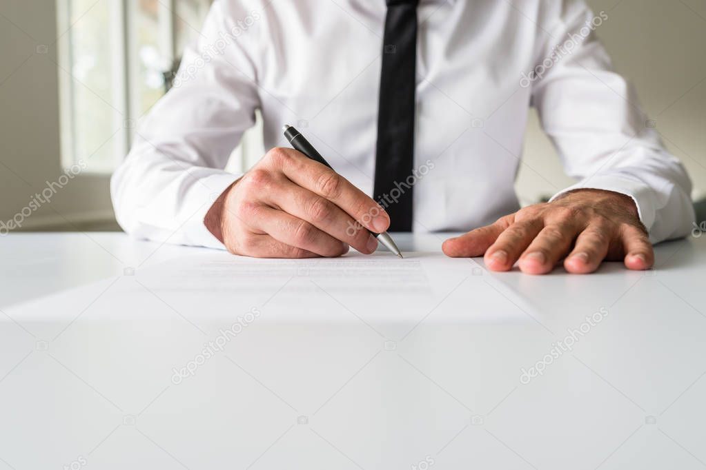 Front view of businessman signing a document
