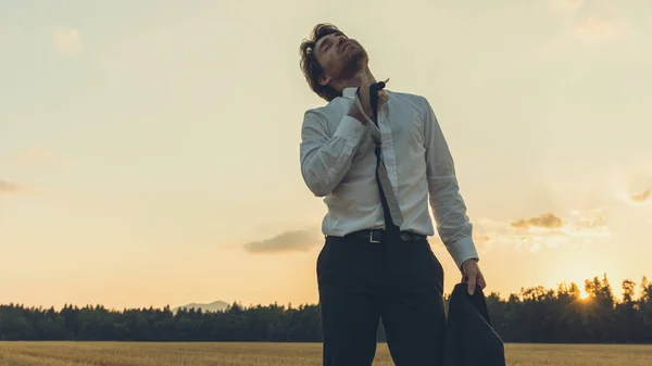 Exhausted businessman standing in nature — Stock Photo, Image