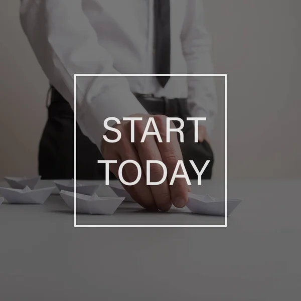 Start today sign over a business leader holding the leading boat — Stock Photo, Image