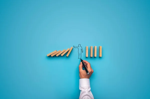 Handdrawn businessman stopping falling dominos — Stock Photo, Image