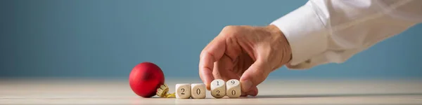 Red christmas bauble next to a 2019 2020 sign — Stock Photo, Image