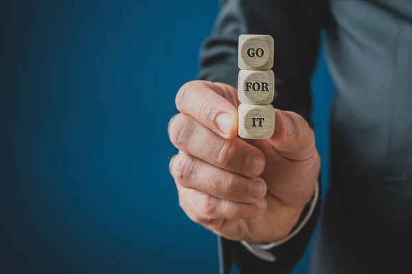 Stacked wooden dices with Go for it sign on them — Stock Photo, Image