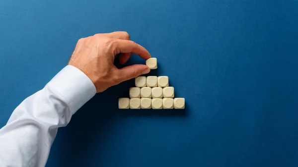 Wooden dices build in pyramid shape — Stock Photo, Image