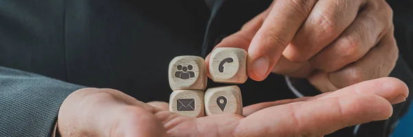 Customer service representative holding wooden dices with contac — Stock Photo, Image