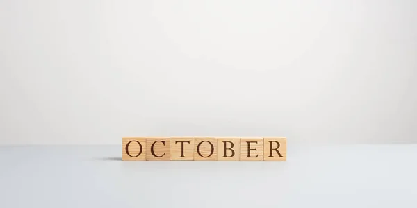 Word October spelled on wooden cubes — Stock Photo, Image