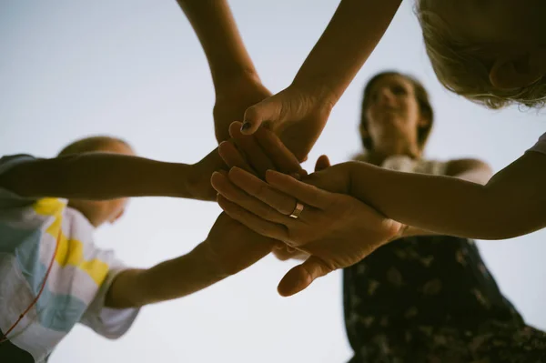 Mother and kids stacking their hands — Stock Photo, Image