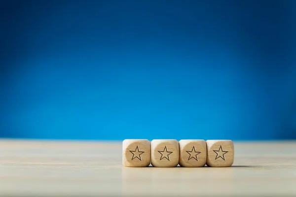 Cuatro estrellas en dados de madera —  Fotos de Stock