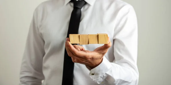 Holding four blank wooden cubes — Stock Photo, Image