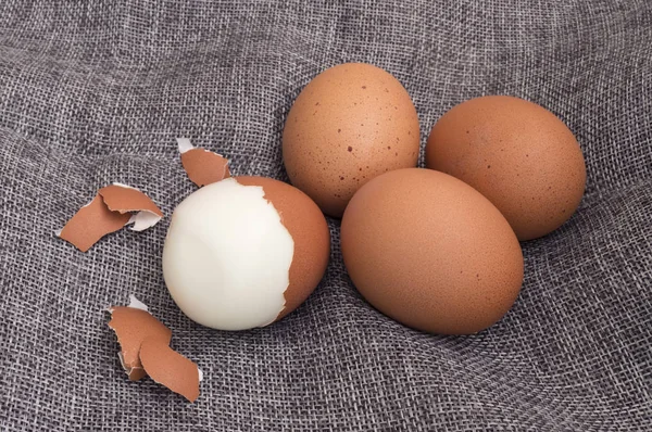 group of medium-hard boiled eggs with their husks
