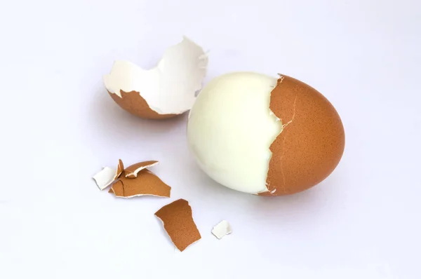 hard boiled eggs and egg shells on white background