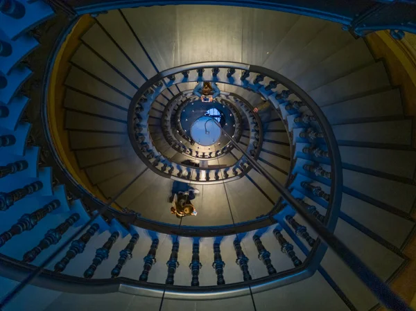 周囲を歩く人々と暗い螺旋階段 — ストック写真