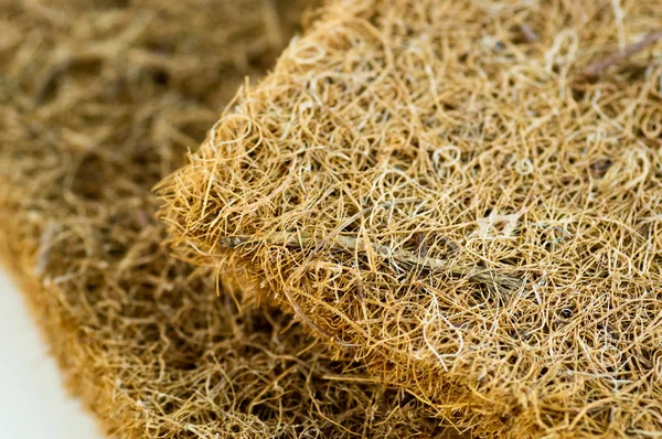 Colchón con fibra de coco. Coco de coco. Cáscara de coco rallada para la producción de colchones. textura, fondo natural . — Foto de Stock