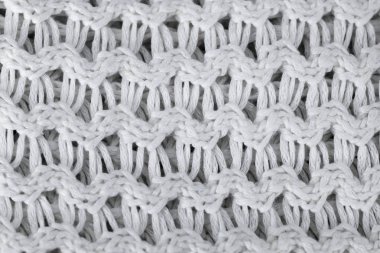 Beyaz örgü yün arka plan. Örme sıcak giysiler kış kumaş doku arka planı için