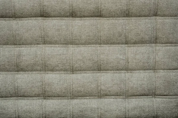 Treinador tipo pano esteiras betonilha apertado com botões. Estilo chesterfield natural acolchoado estofos fundo close up. textura de fundo — Fotografia de Stock