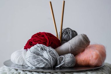 çok renkli iplik örme bir tabak içinde için. İplik örme üzerinde beyaz bir arka plan için. Örgü dikiş bir tür olarak. Örgü iğneleri