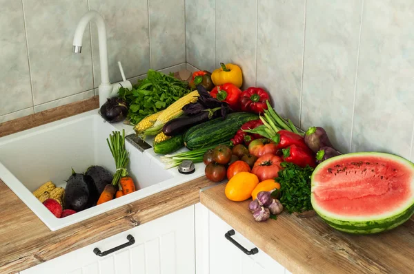 Washing fruits and vegetables close-up. Fresh vegetables splashing in water before cooking