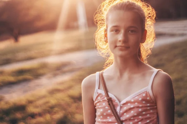 Портрет красивої молодої дівчини у вечірньому сонячному світлі на природі. дівчина насолоджується літом і сонячною погодою на лузі — стокове фото