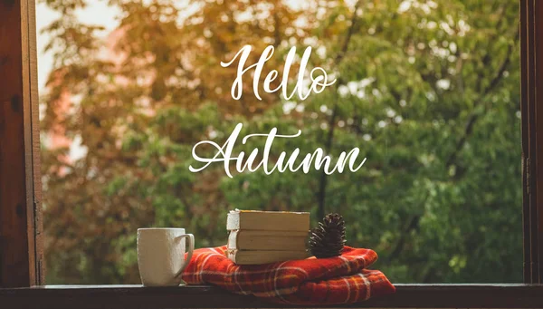Hello Autumn. Cozy autumn still life: cup of hot coffee and opened book on vintage windowsill and rain outside. Autumn. Rain