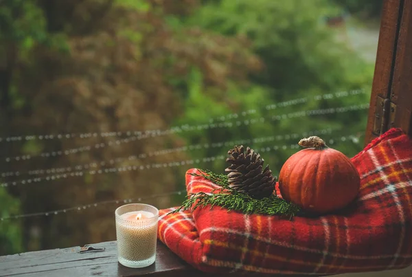 Cozy autumn still life: cup of hot coffee and opened book on vintage windowsill and rain outside. Autumn. Apartment. Rain