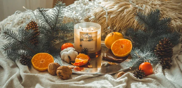 Tangerines in a winter composition, Christmas trees, candles, cones, cotton, cinnamon, garlands. Symbol of New Year and Christmas — Stock Photo, Image