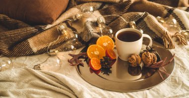 Fincan çay veya kahve, kar taneleri şeklinde kurabiye ile portakal Noel süsleri ve fındık ile Noel natürmort