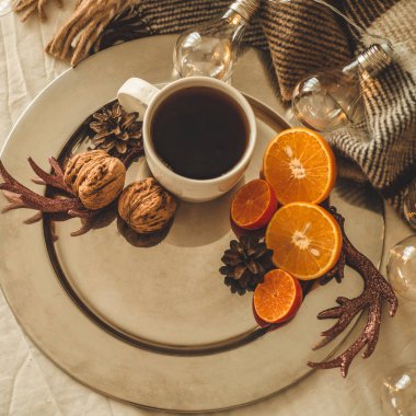 Fincan çay veya kahve, kar taneleri şeklinde kurabiye ile portakal Noel süsleri ve fındık ile Noel natürmort